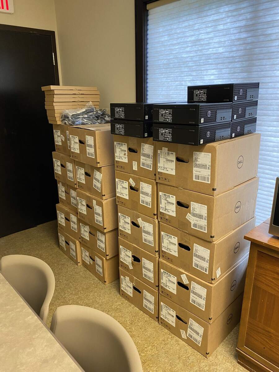 Stacks of Dell boxes and small-form PCs ready for a rollout